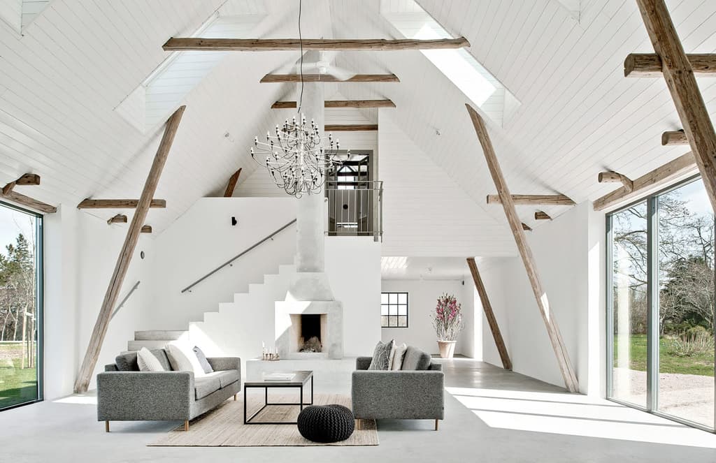 A ruined barn is revived as a minimalist country retreat in Sweden