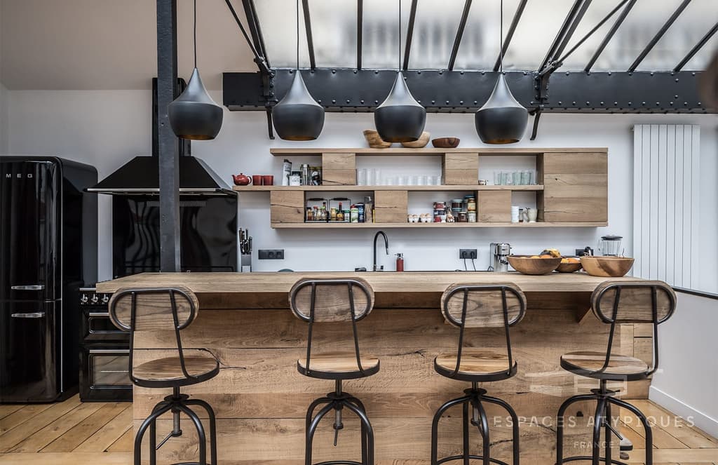 The kitchen fuses industrial and rustic elements