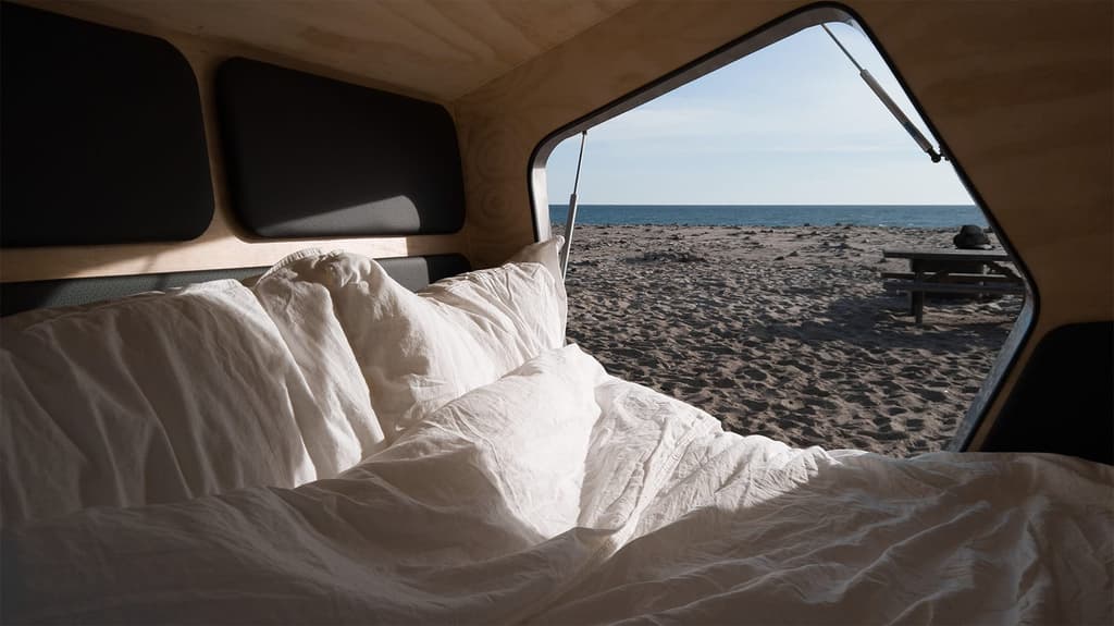 Inside the Polydrop camper - it features minimalist pine walls and leather detailing