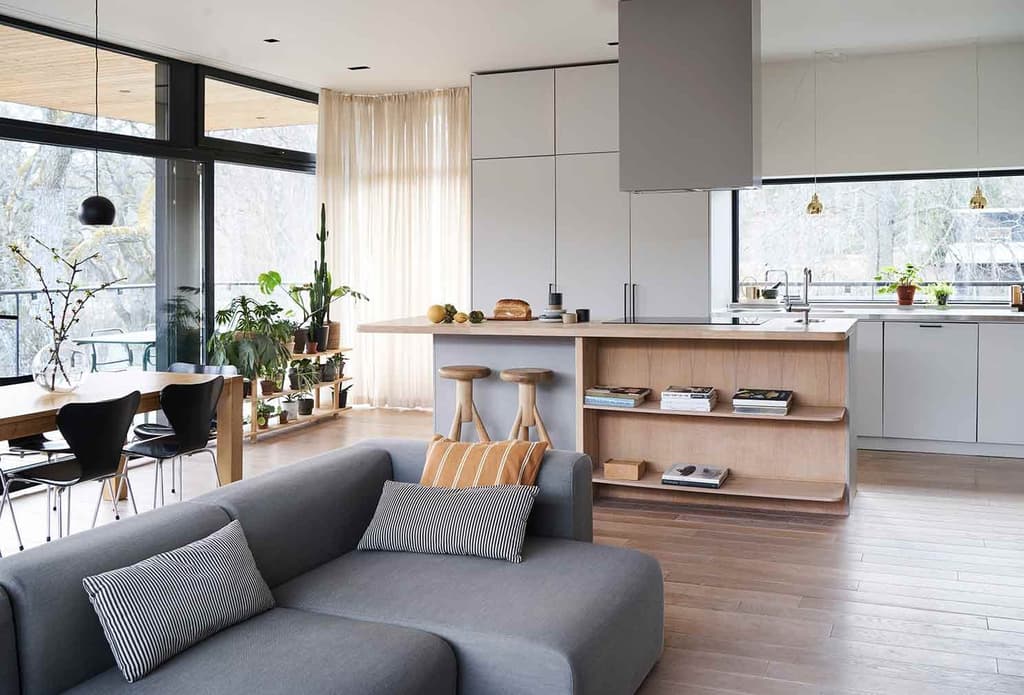 A minimalist Swedish home floats above a rocky outcrop in Värmdö