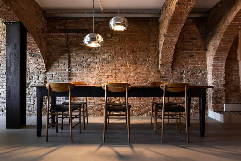 A Tuscan stable is reborn as a industrial loft with secret swimming pool