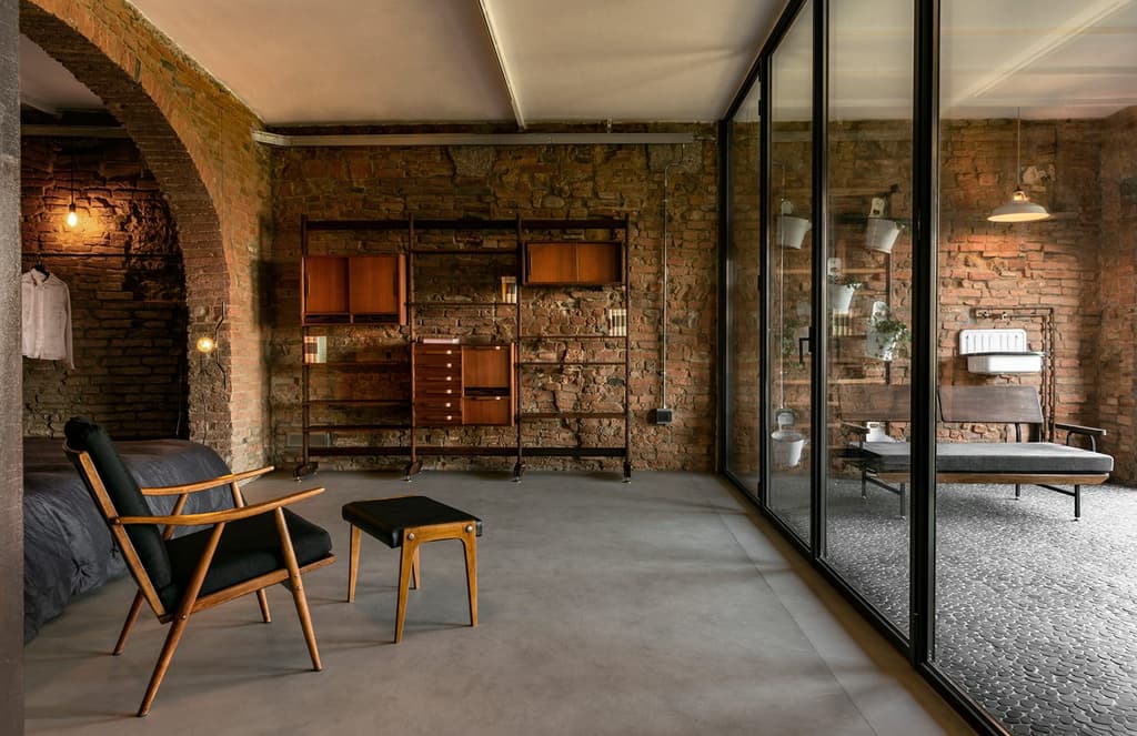 A Tuscan stable is reborn as an industrial loft with a secret swimming pool
