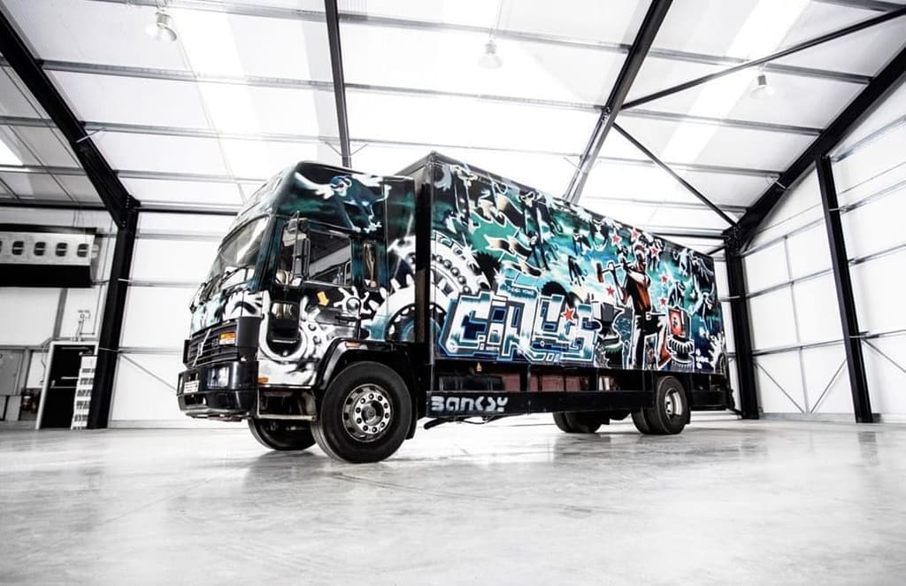 A graffiti-covered truck by Banksy heads to auction
