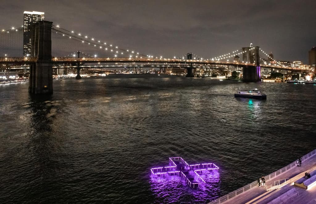 A glowing cross is floating on Manhattan’s East River