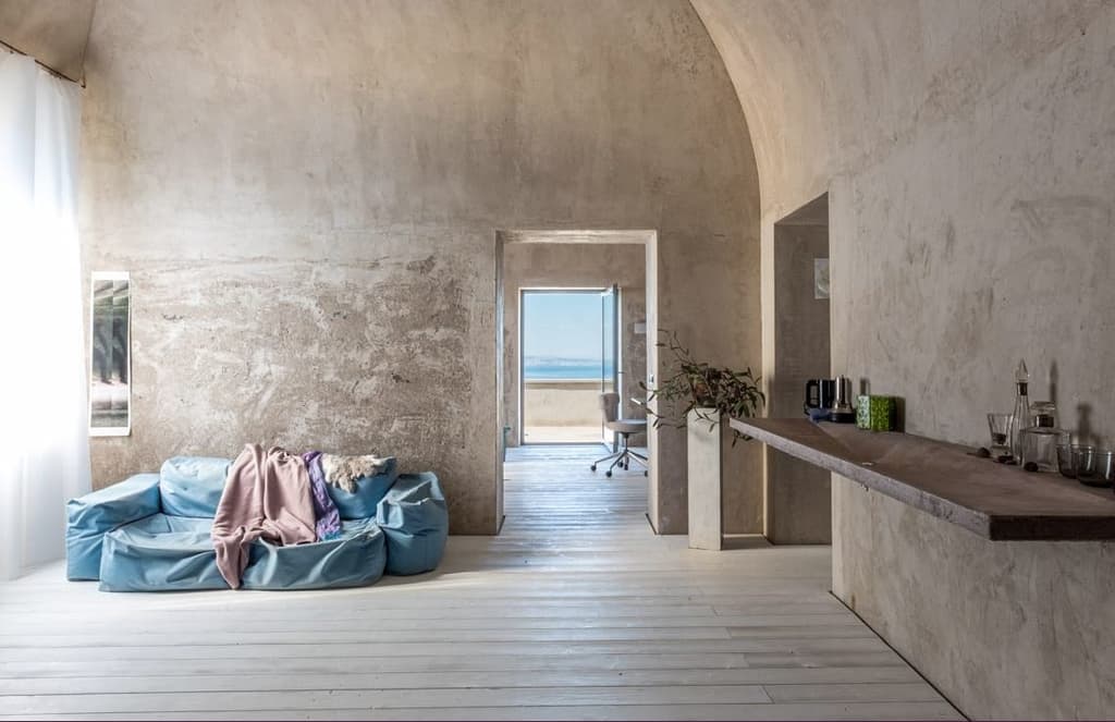 A converted olive oil factory with raw interiors is for sale in Italy