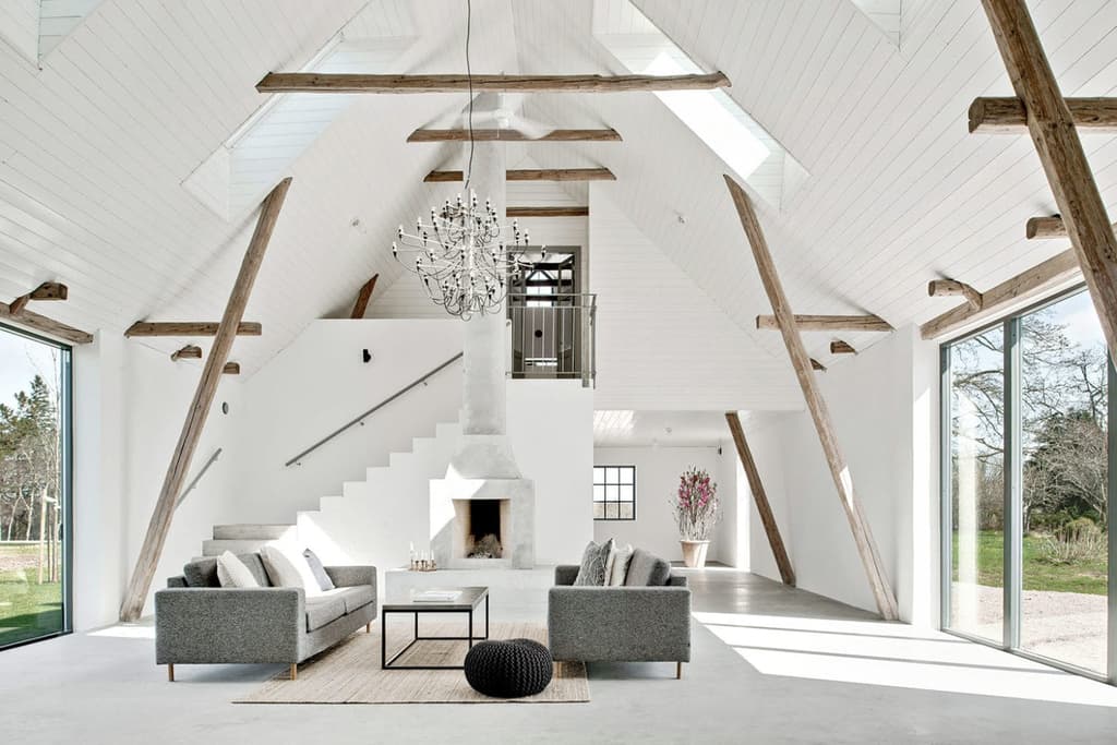 A pair of dilapidated barns were converted to create this minimal four-bedroom home Tunby, Österlen