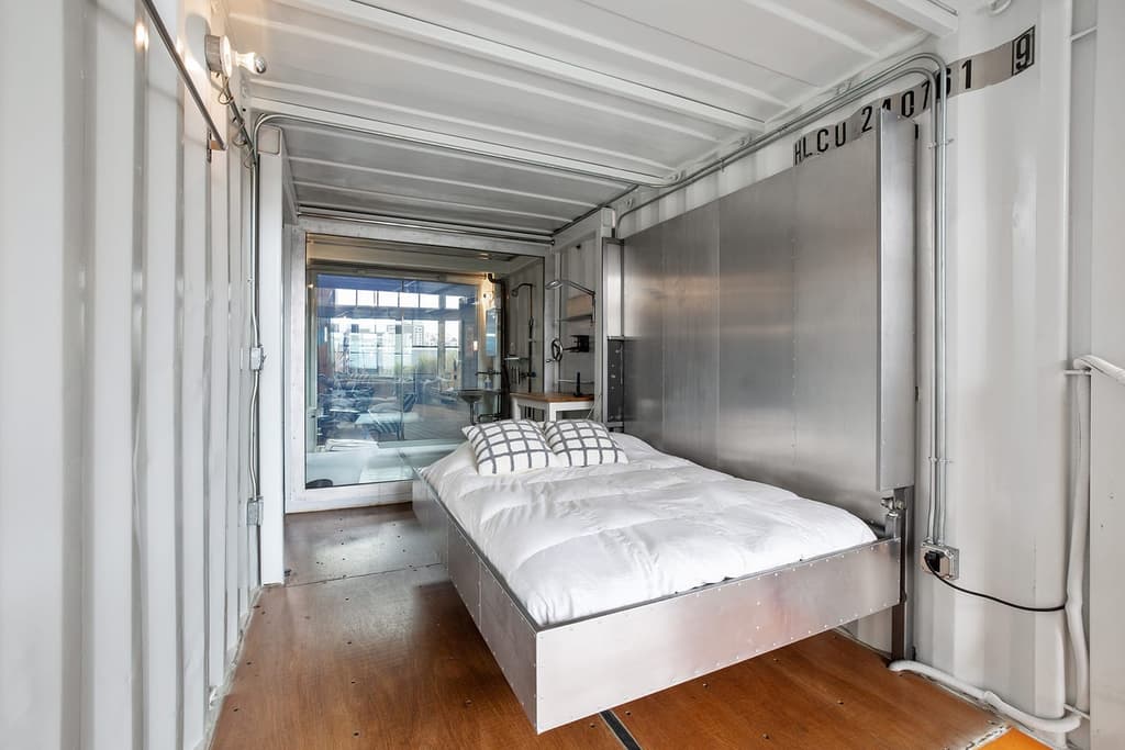 Stacked shipping containers sit inside this sprawling warehouse loft in San Francisco's Fillmore District, juxtaposing industrial brick bones with rugged steel.