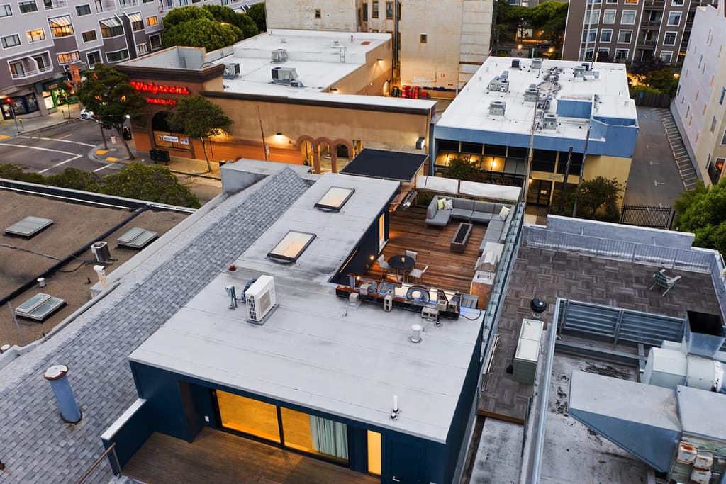 Stacked shipping containers sit inside this sprawling warehouse loft in San Francisco's Fillmore District, juxtaposing industrial brick bones with rugged steel.