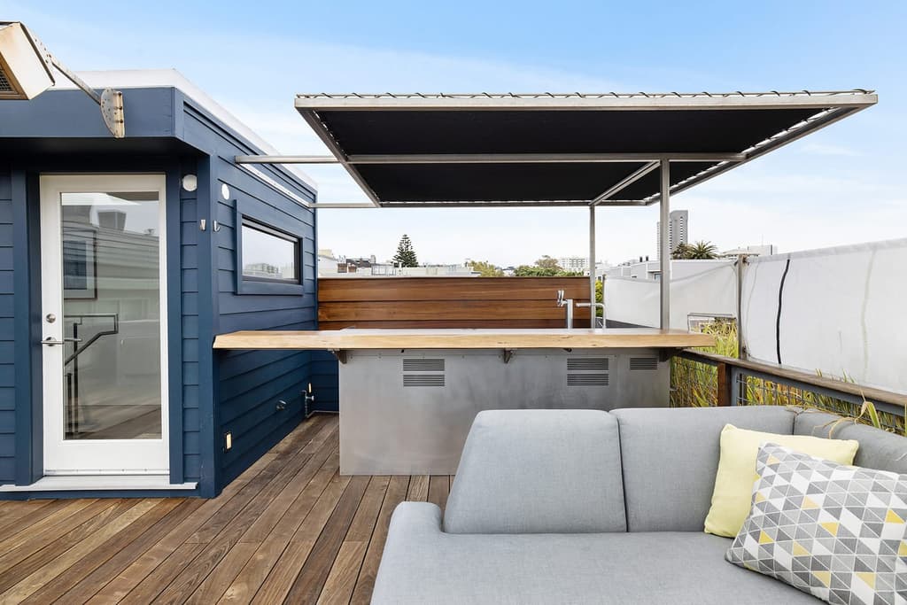Stacked shipping containers sit inside this sprawling warehouse loft in San Francisco's Fillmore District, juxtaposing industrial brick bones with rugged steel.
