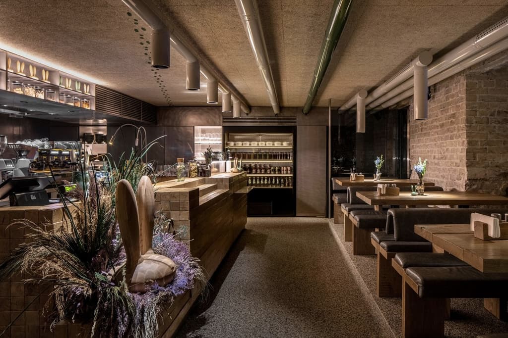 Counters and furniture have been built using salvaged blocks and planks of timber – fashioned from historic Carpathian house beams.