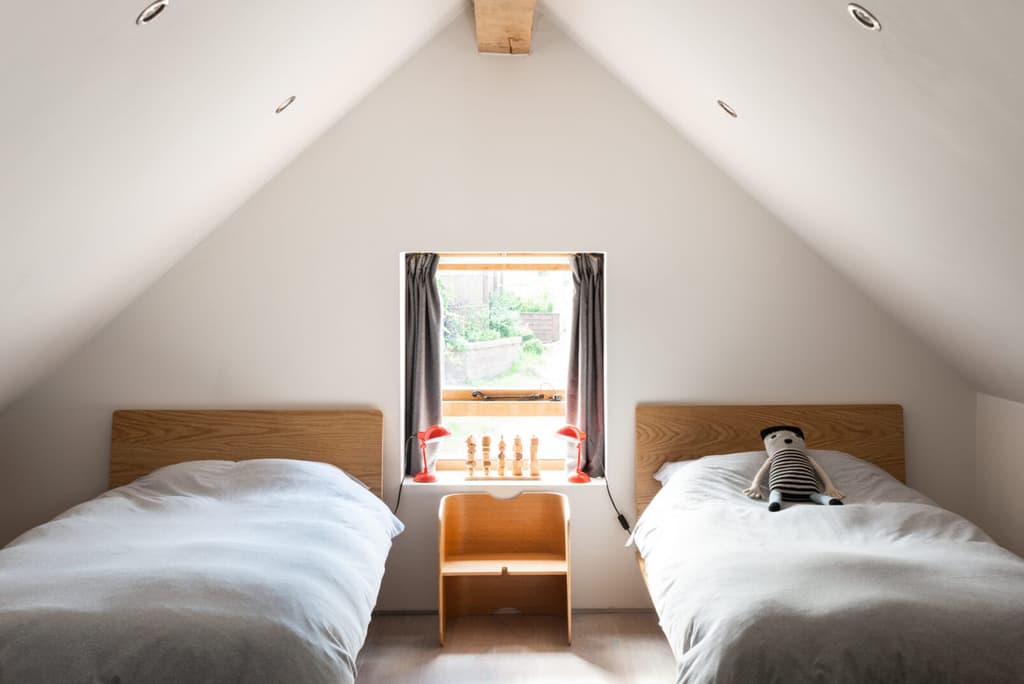 Gabled ceilings and thick oak beams add character in the bedrooms.