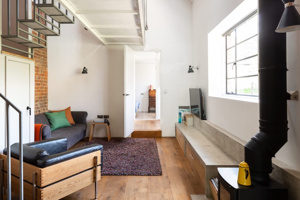 These industrial features inspire contemporary interventions, such as wide oak floorboards, handmade cabinetry and cast concrete shelving.