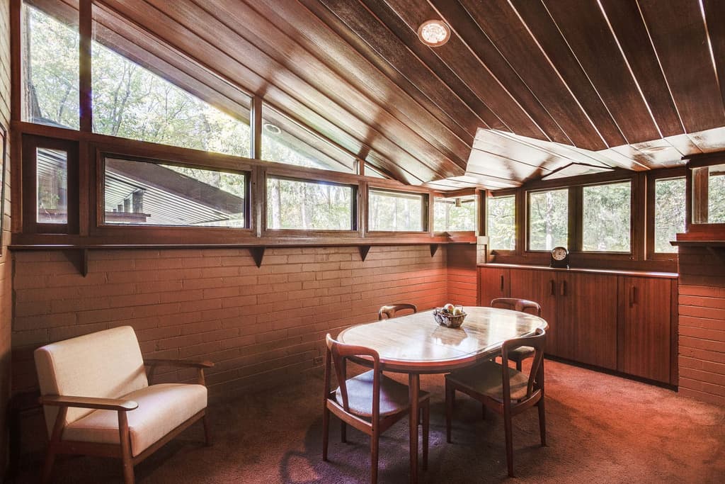 T Carr Residence has exposed brick walls, clerestory and ribboned windows and sloping mahogany ceilings