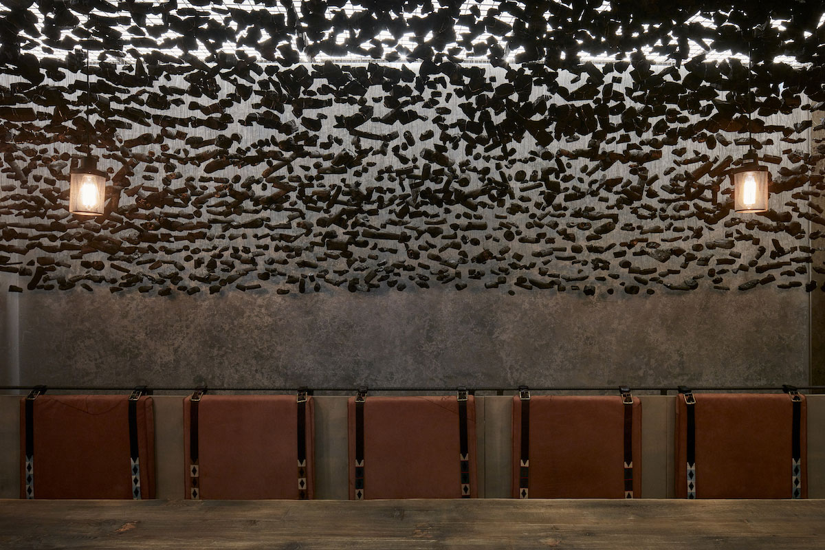 Customers order Argentinian steak and blood sausage whilst sat on benches hewn from steel beams