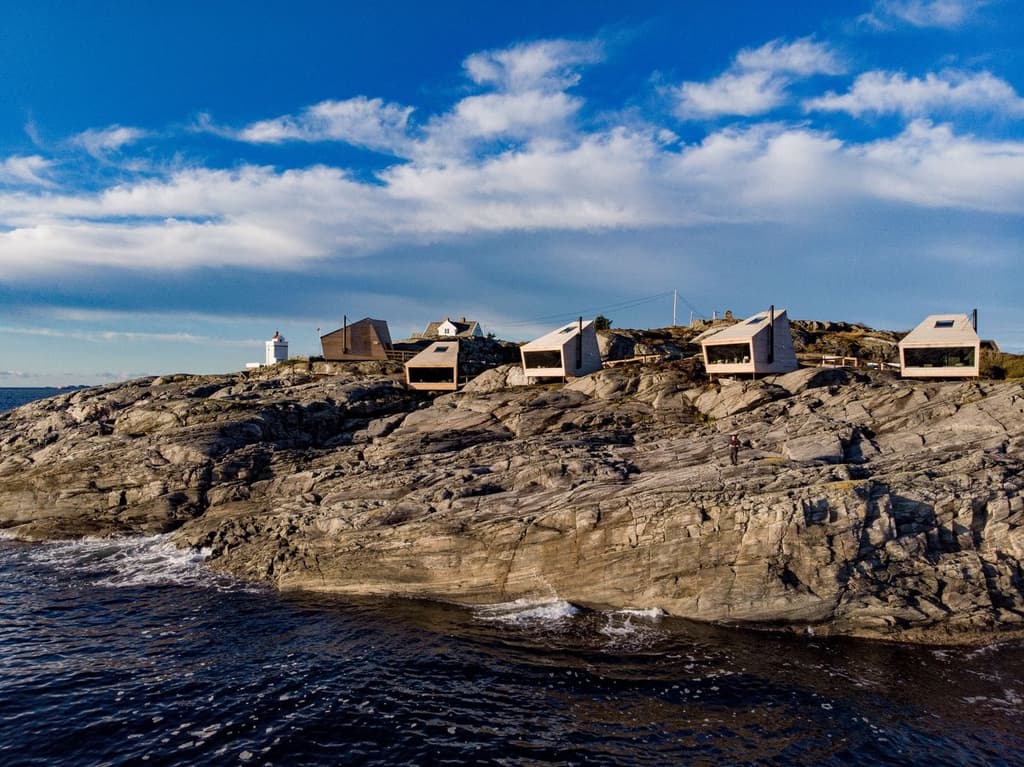 Flokehyttene cabins perch on a rocky headland in western Norway