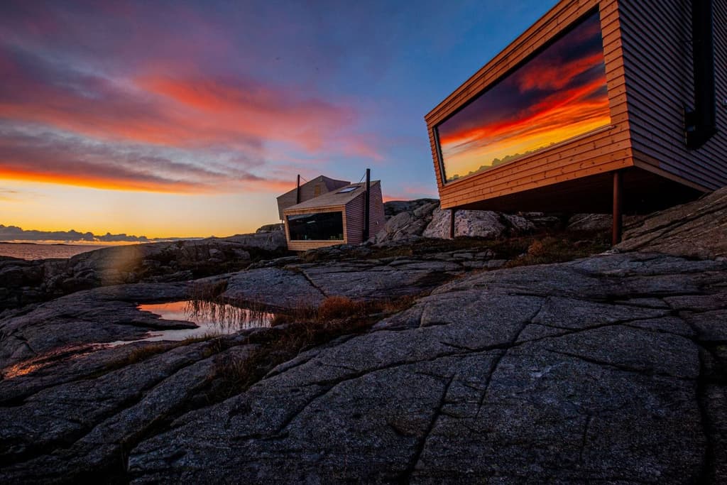 Flokehyttene cabins perch on a rocky headland in western Norway