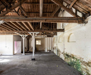 The red brick building sits on the banks of the River Colne and is a vacant shell that’s already been stripped back to its bones