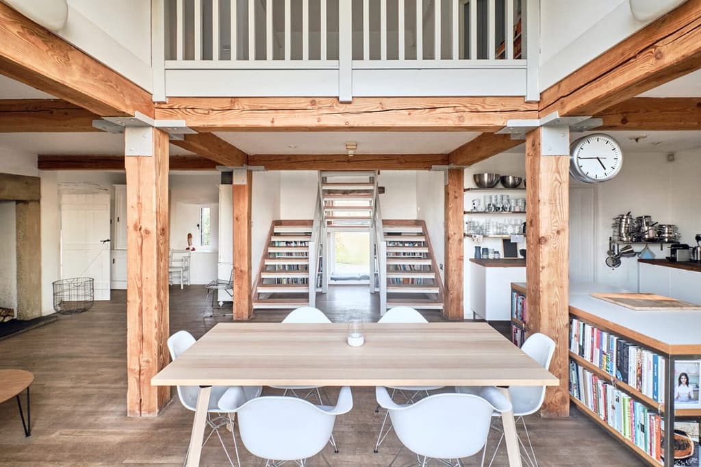A mezzanine level overlooks the open plan, double-height living room and dining room below.