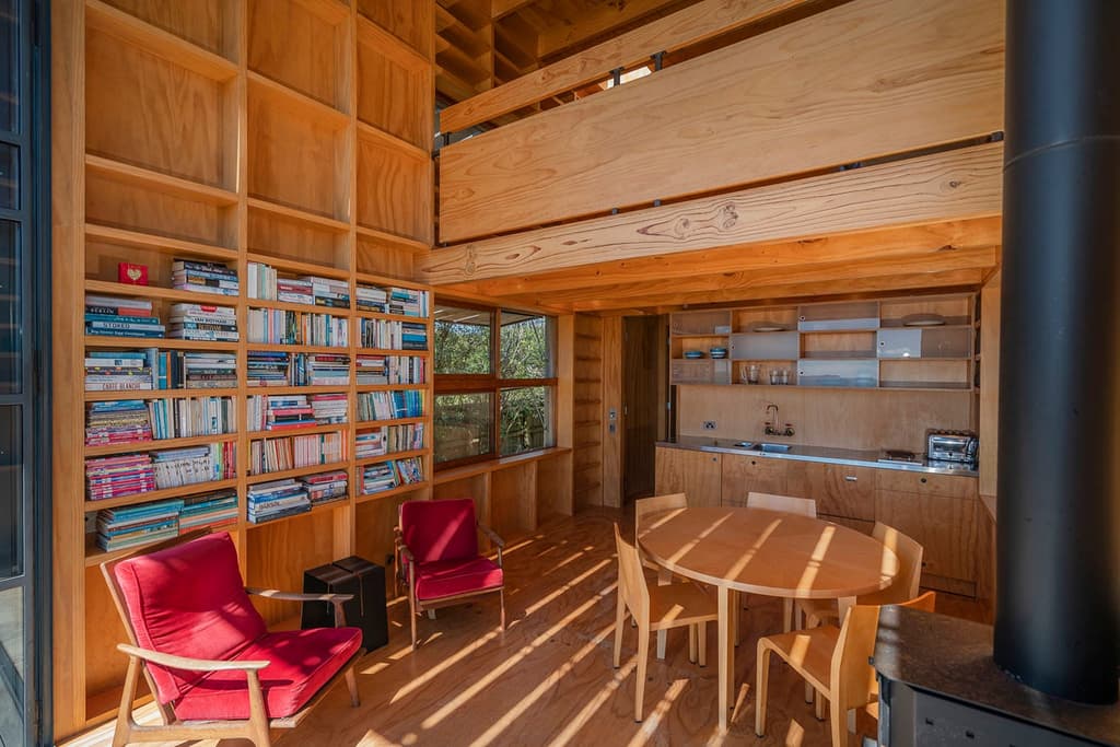 This award-winning New Zealand coastal cabin has been built on wooden runners, limiting impact on its natural environment while enabling it to be easily towed away