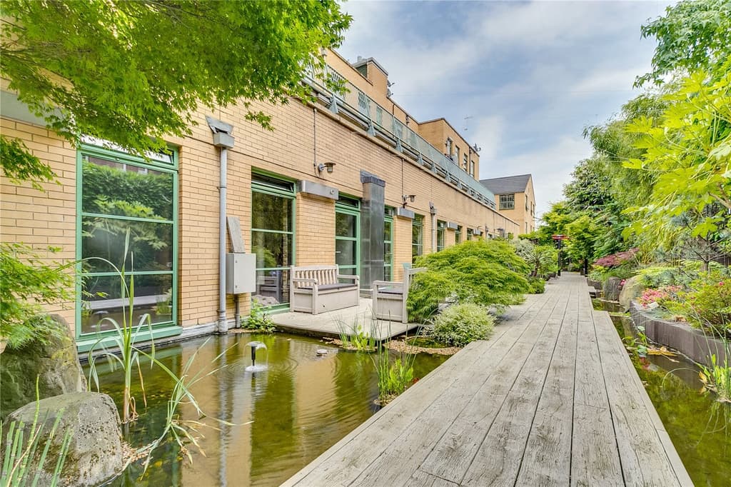 The flat is one of six homes accessed through Japanese water gardens, each with a private bridge to the front door.
