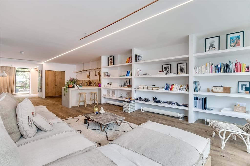 The apartment is inside the Piers Gough-designed Glass Building and is one of six homes accessed through Japanese water gardens, each with a private bridge to the front door.