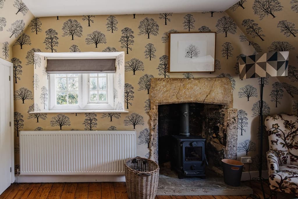 One of the bedrooms on the upper floor. Note the stone hearth and stove