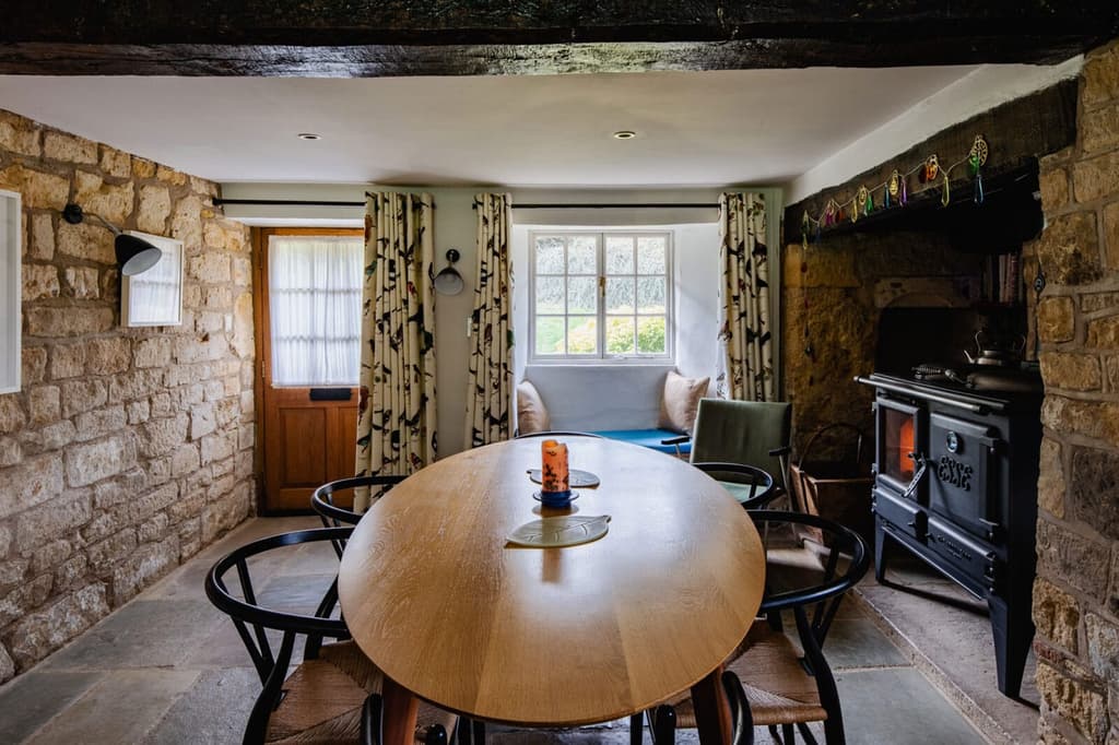 The ground floor has a separate dining room with flagstone floors, limestone walls and an inglenook fireplace