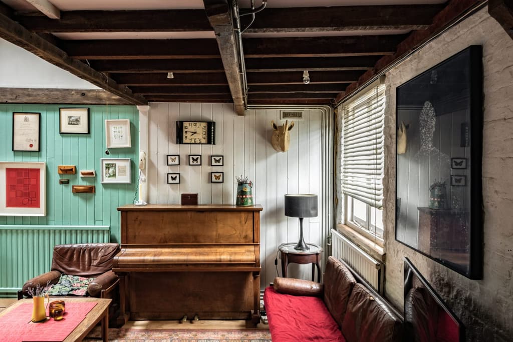 A snug living room is set beneath one of the old raftered haylofts