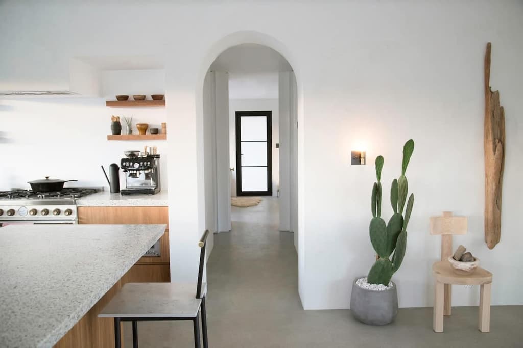 Archways lead sight-lines through the whitewashed home
