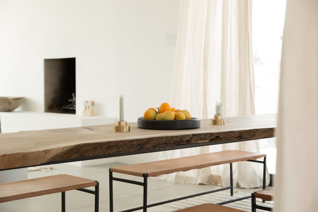 A table and bench by Jøna Maaryn inside the home