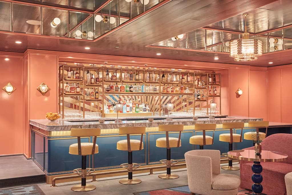 Reflective ceilings help suffuse rooms with light and colour, while tub-shaped cocktail chairs and scalloped seats take members back to Hollywood’s golden era.