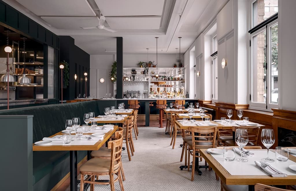 Québec restaurant Le Clocher Penché’s classical interiors reflect its former life as a bank