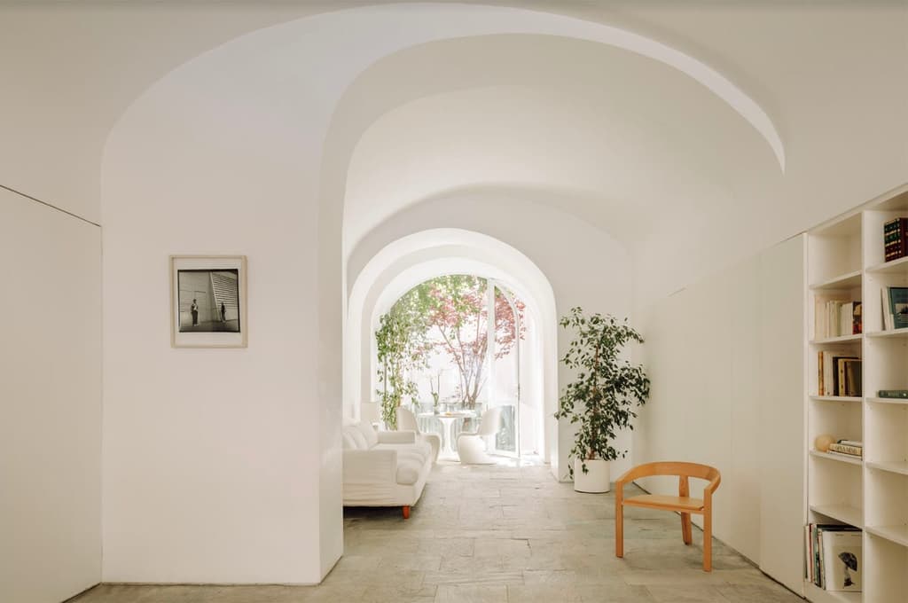 Interiors are minimalist, with focus placed on clean lines and skilled craftsmanship, while smooth arches and cool stone floors add drama to the architectural framing of its spaces.