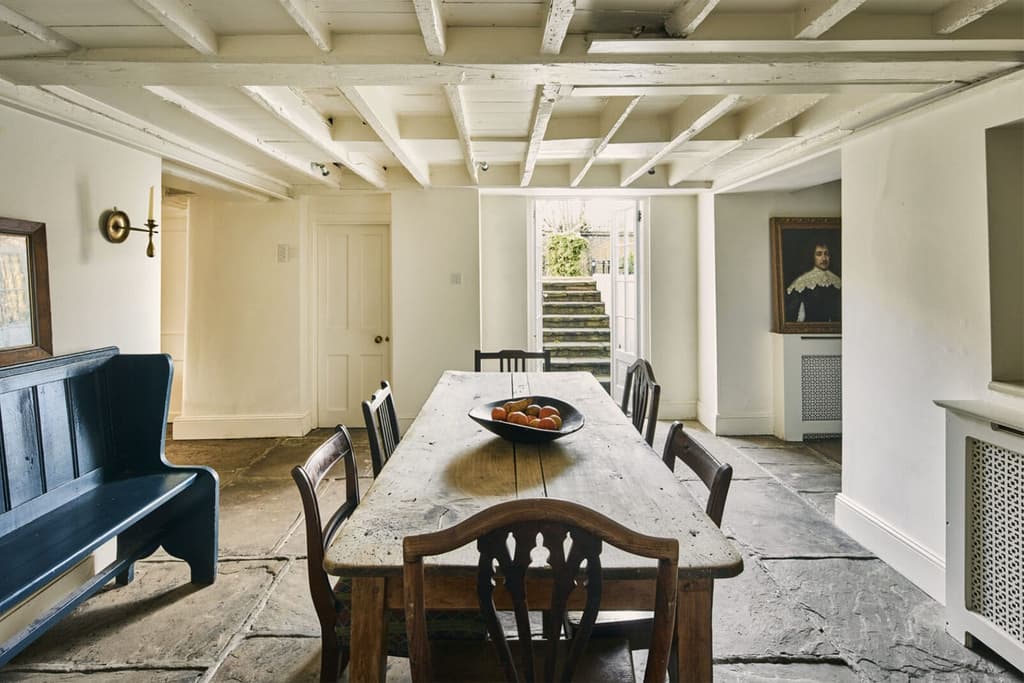 Painted rafters in the dining room showcase the low ceilings in this part of the home – previously the domain of domestic servants
