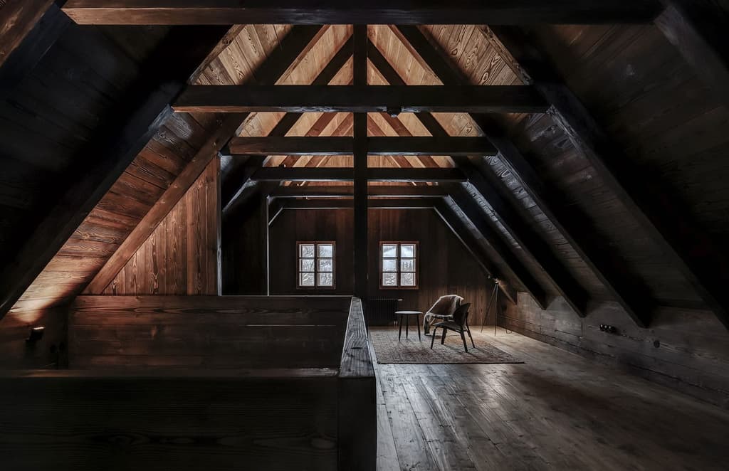 Mezi Lukami is a Czech mountain refuge with minimalist, moody interiors