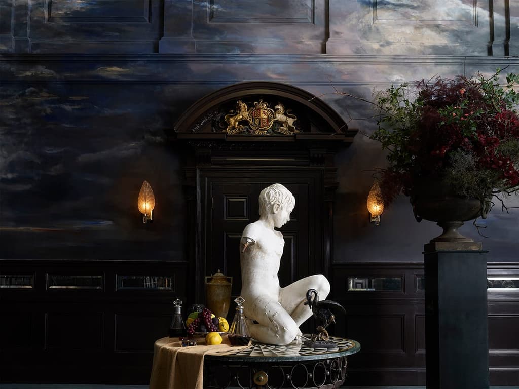 A corner of NoMad Restaurant with its moody paint effect