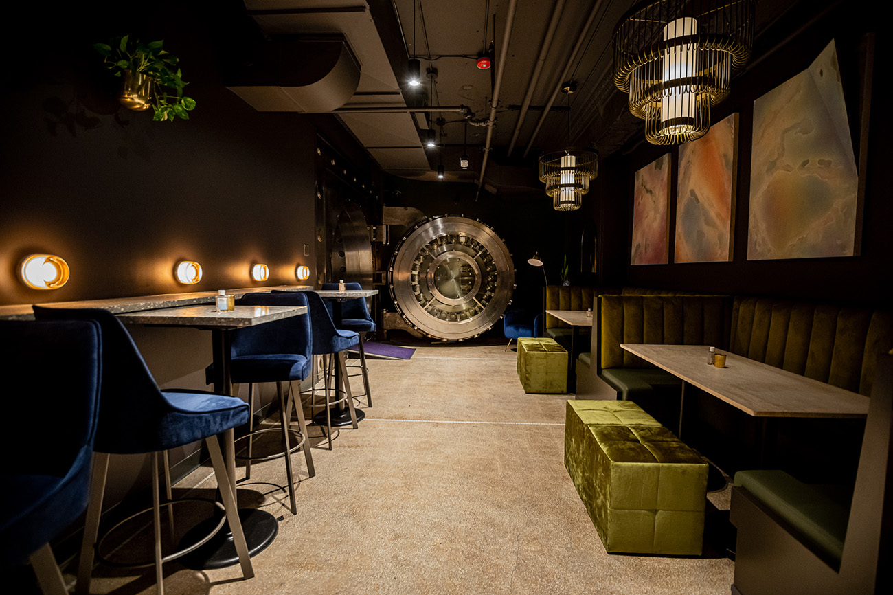 The main feature of the space is the buffed steel bank vault door which forms a slick backdrop for seating