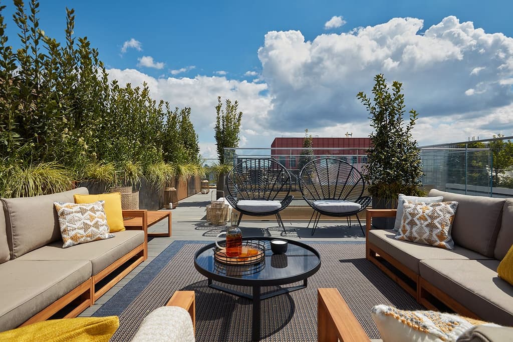 The apartment has a private terrace area with landscaping