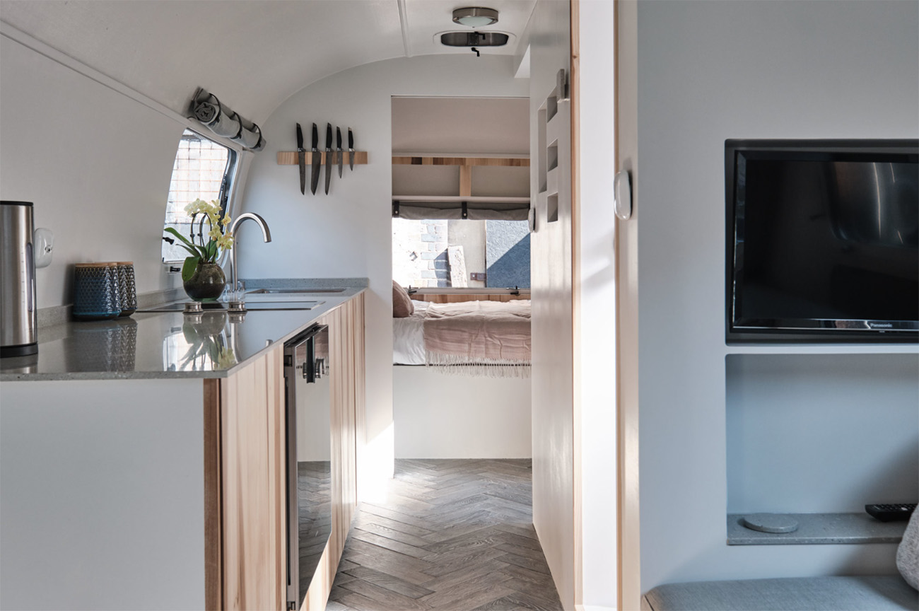 Interiors of the midcentury trailer have been modernised via parquet oak flooring finished with shou sugi ban and white Osmo oil