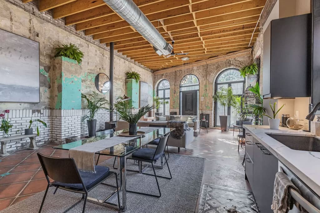 Exposed brick, rafters and Victorian style ceramic tiles in the front of the building, which has a kitchen and dining area