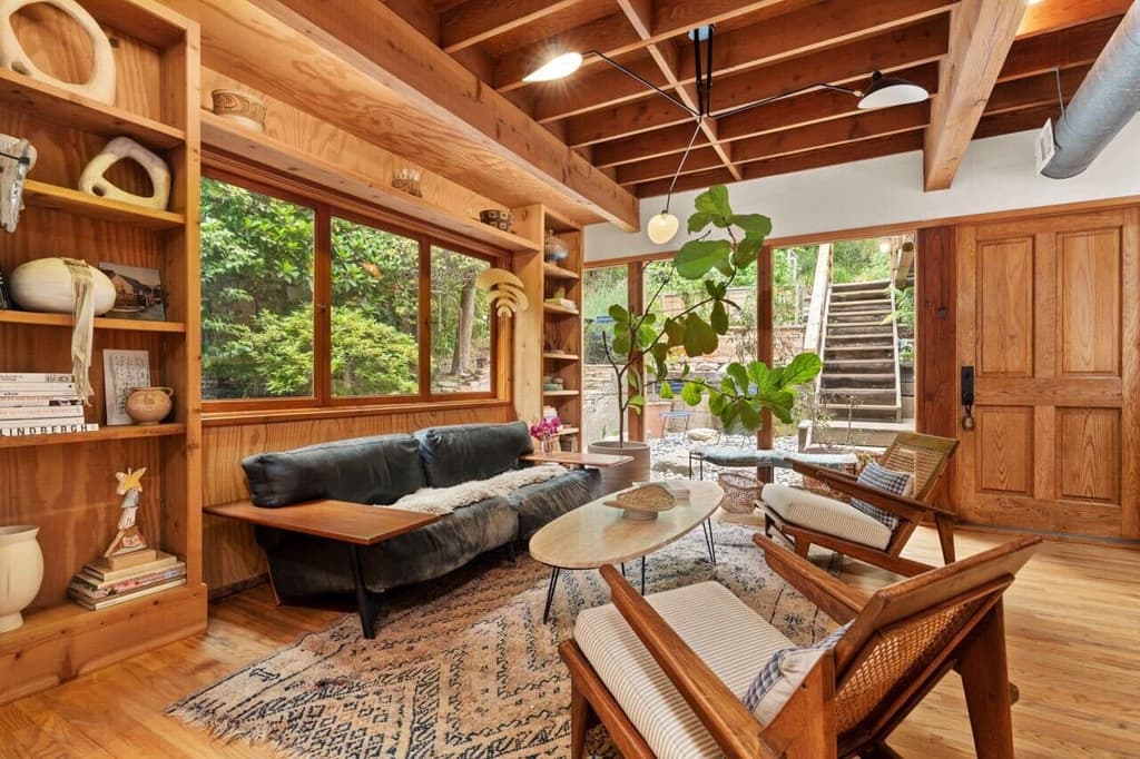 Interiors have a treehouse bent thanks to excessive timber and exposed rafters