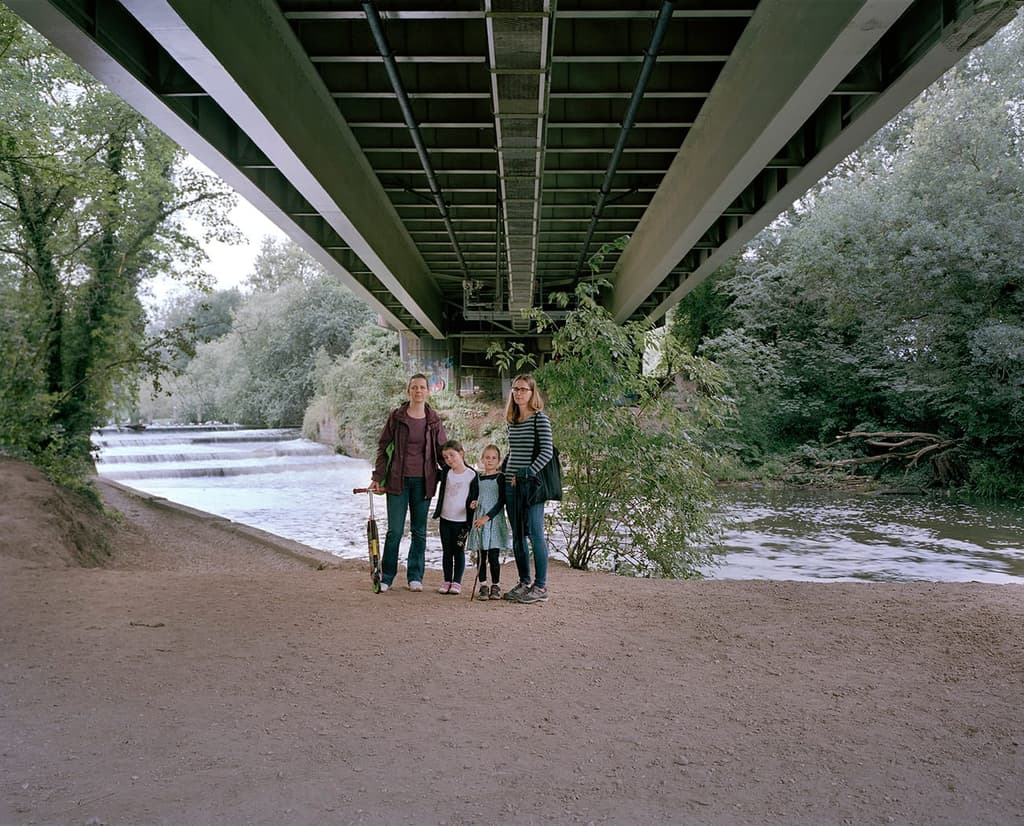 A family photographed by Andrew Meredith beneath the M4 motorway