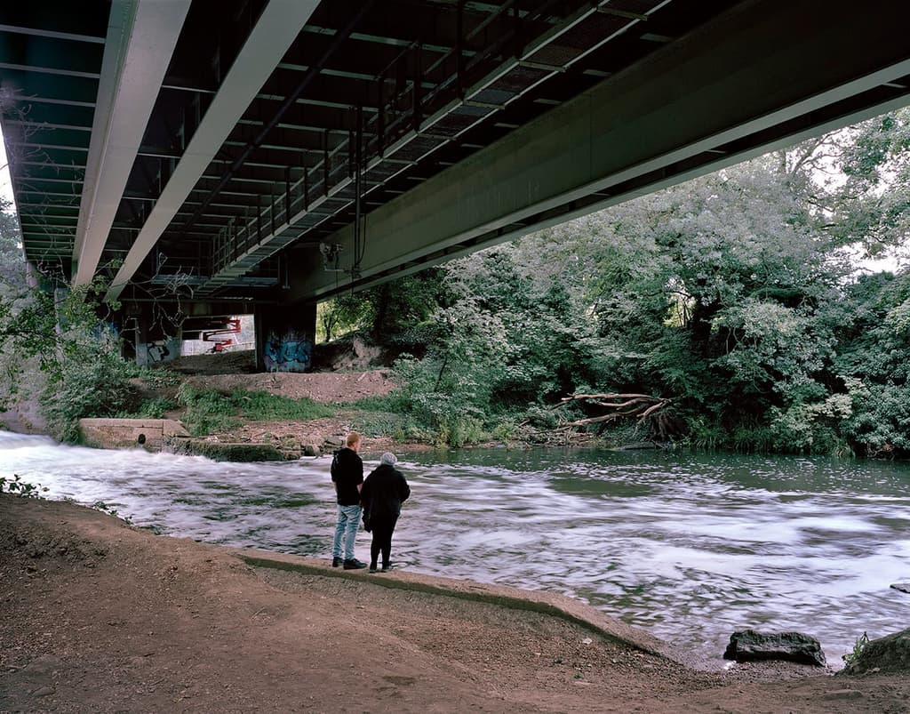 Water coursing beneath the concrete bridge above