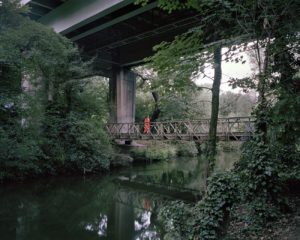 A construction worker passes along the walkway