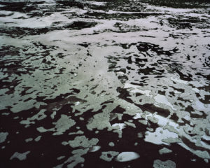 A show of the water current, breaking around rocks