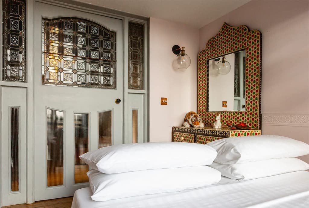 Period details include stained glass extra wide doors