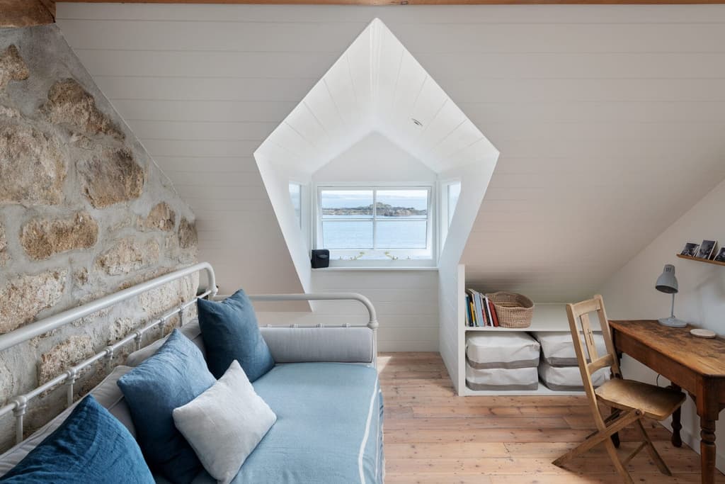 The upper level is laid out as a studio or spare bedroom