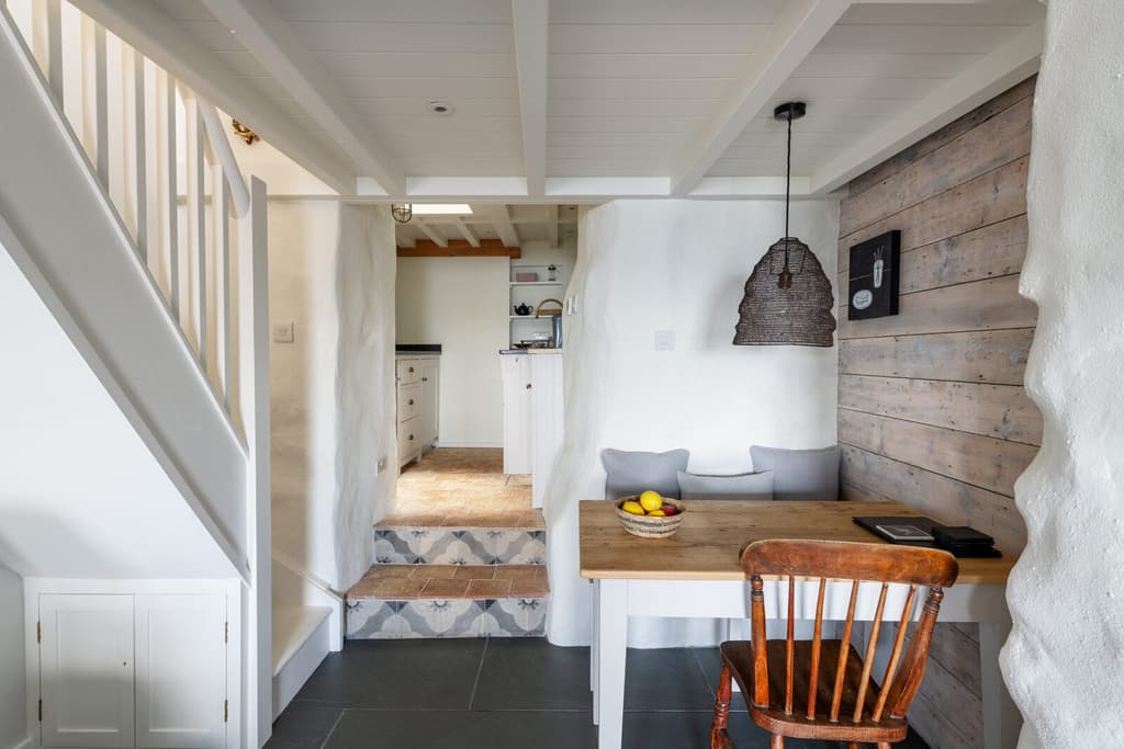 The ground floor is largely open plan, comprising the living room, dining nook and galley kitchen