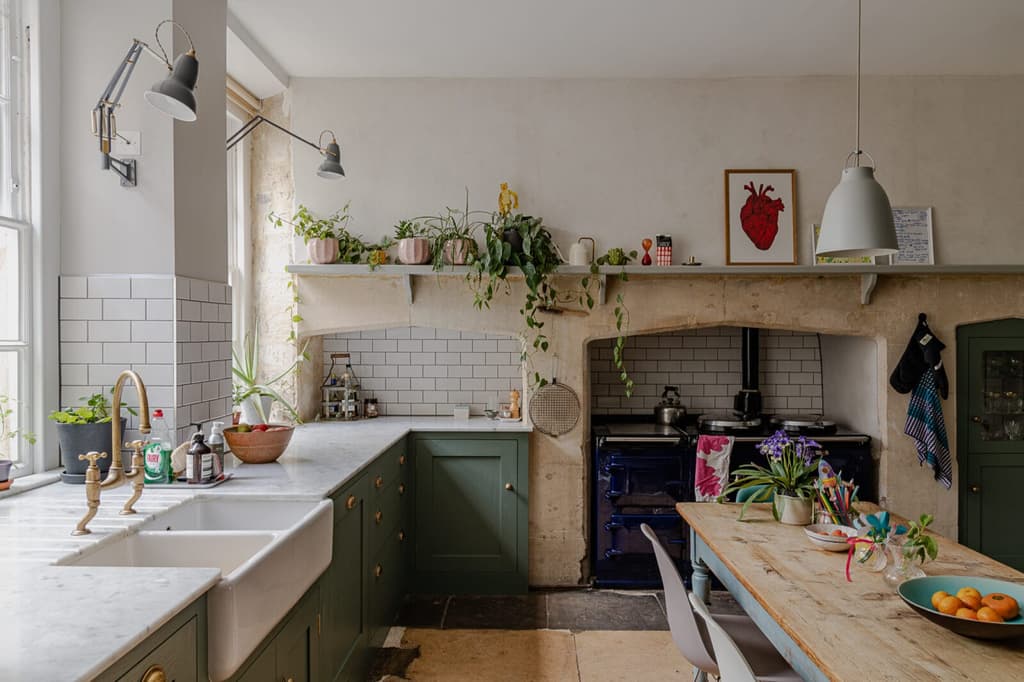 The kitchen has been sensitively updated in keeping with the style of the home: updated cabinets, a double sink and blue aga work effortlessly with stone bath fireplaces