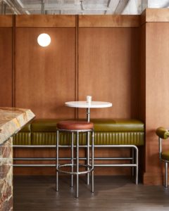 Mossy hues and wood panelling set a sophisticated tone